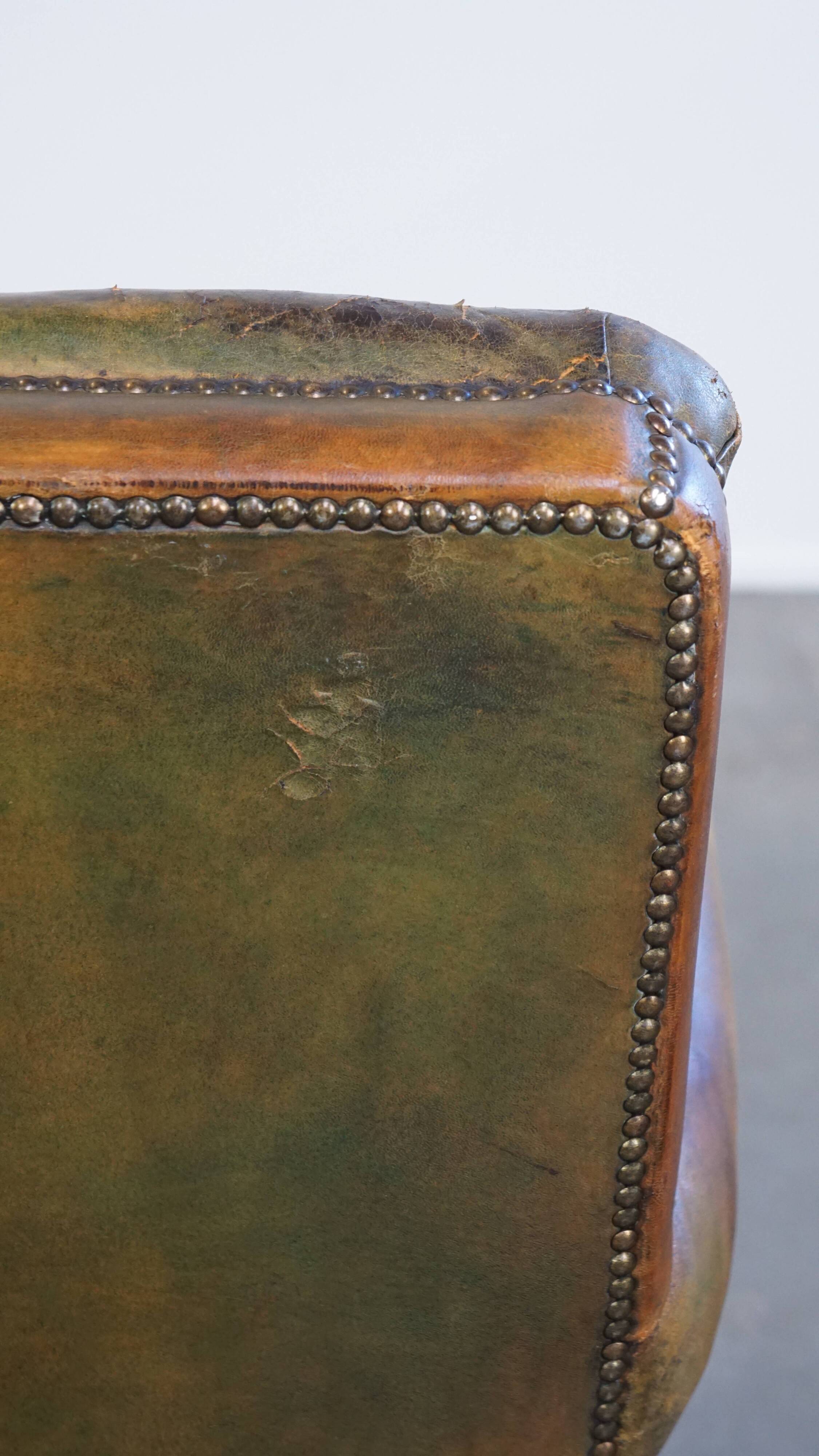 Green antique English cowhide leather armchair on wheels