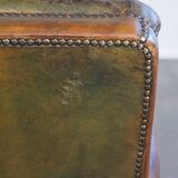Green antique English cowhide leather armchair on wheels