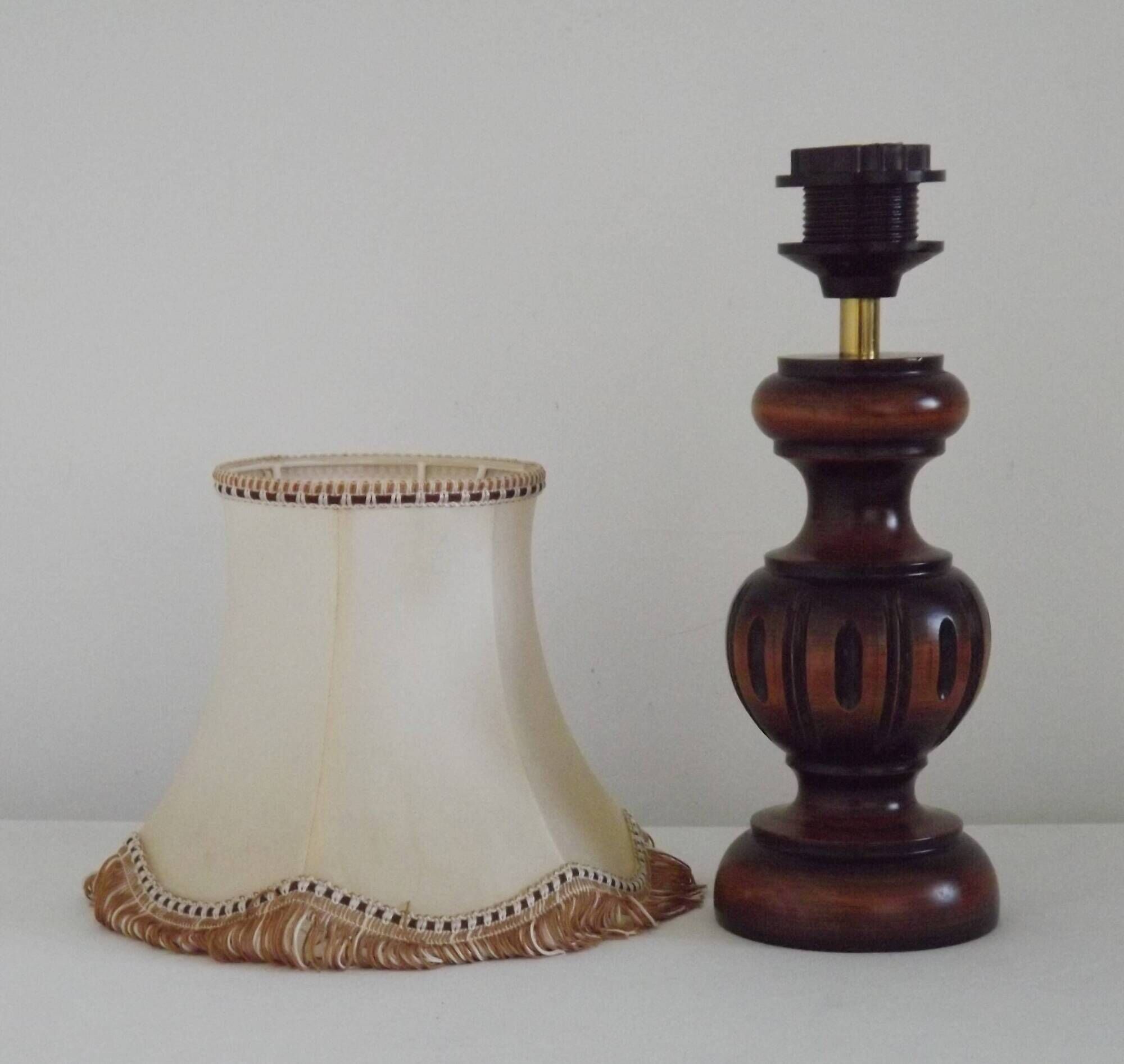 Mid-century French table lamp made of turned carved wood with a fringed shade.