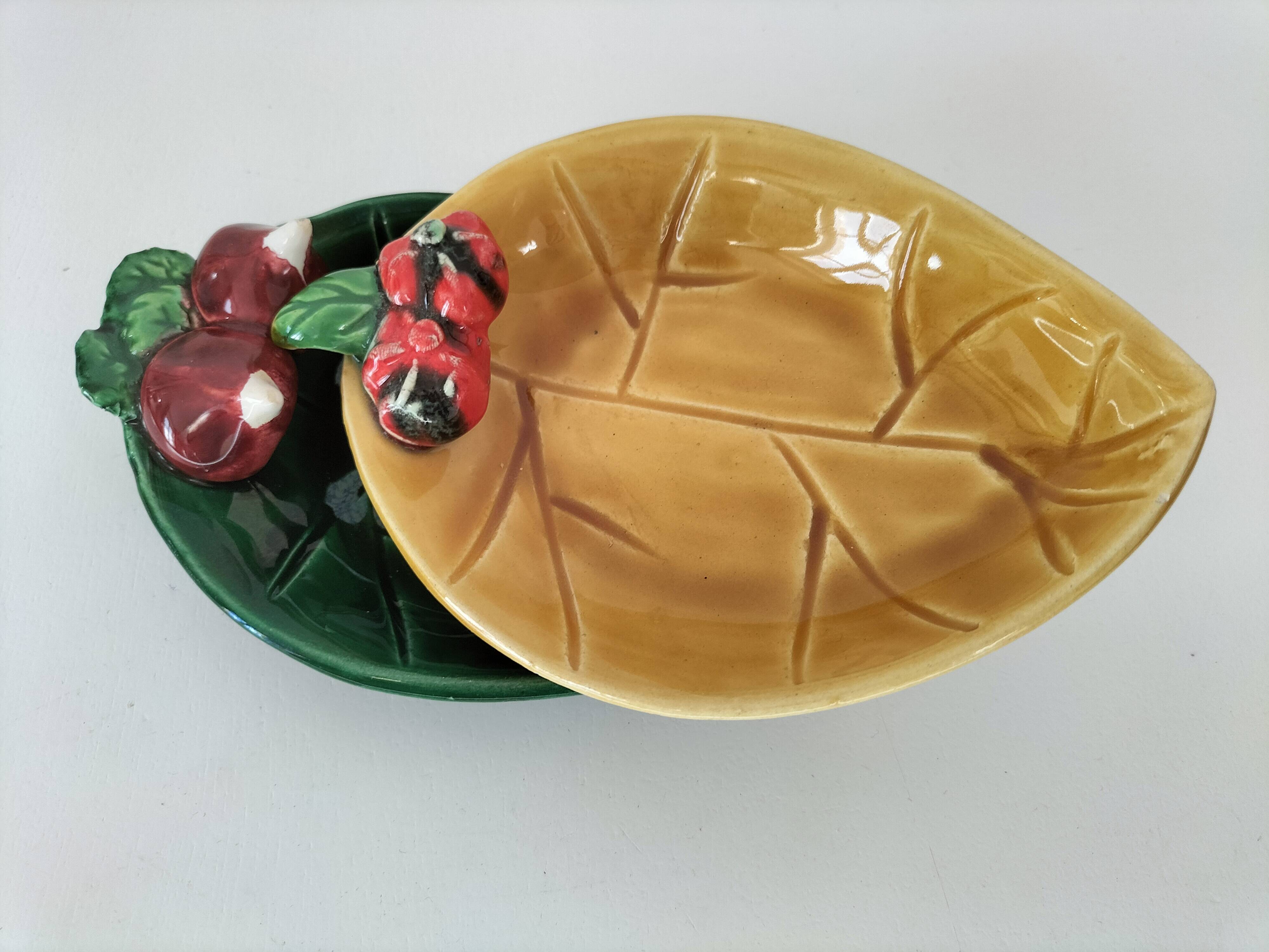 Two relief bowls with leaf designs, radishes, and tomatoes.