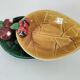 Two relief bowls with leaf designs, radishes, and tomatoes.