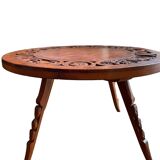 Circular tripod coffee table in carved wood