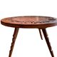 Circular tripod coffee table in carved wood