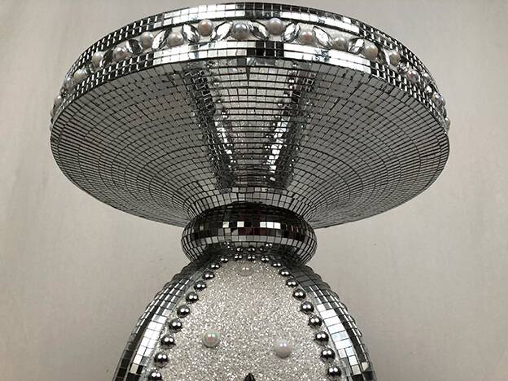 Small wooden pedestal table entirely covered with mirror mosaic