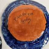 Suite of decorative plates empty enamelled terracotta pockets signed "Gerlou", unique pieces