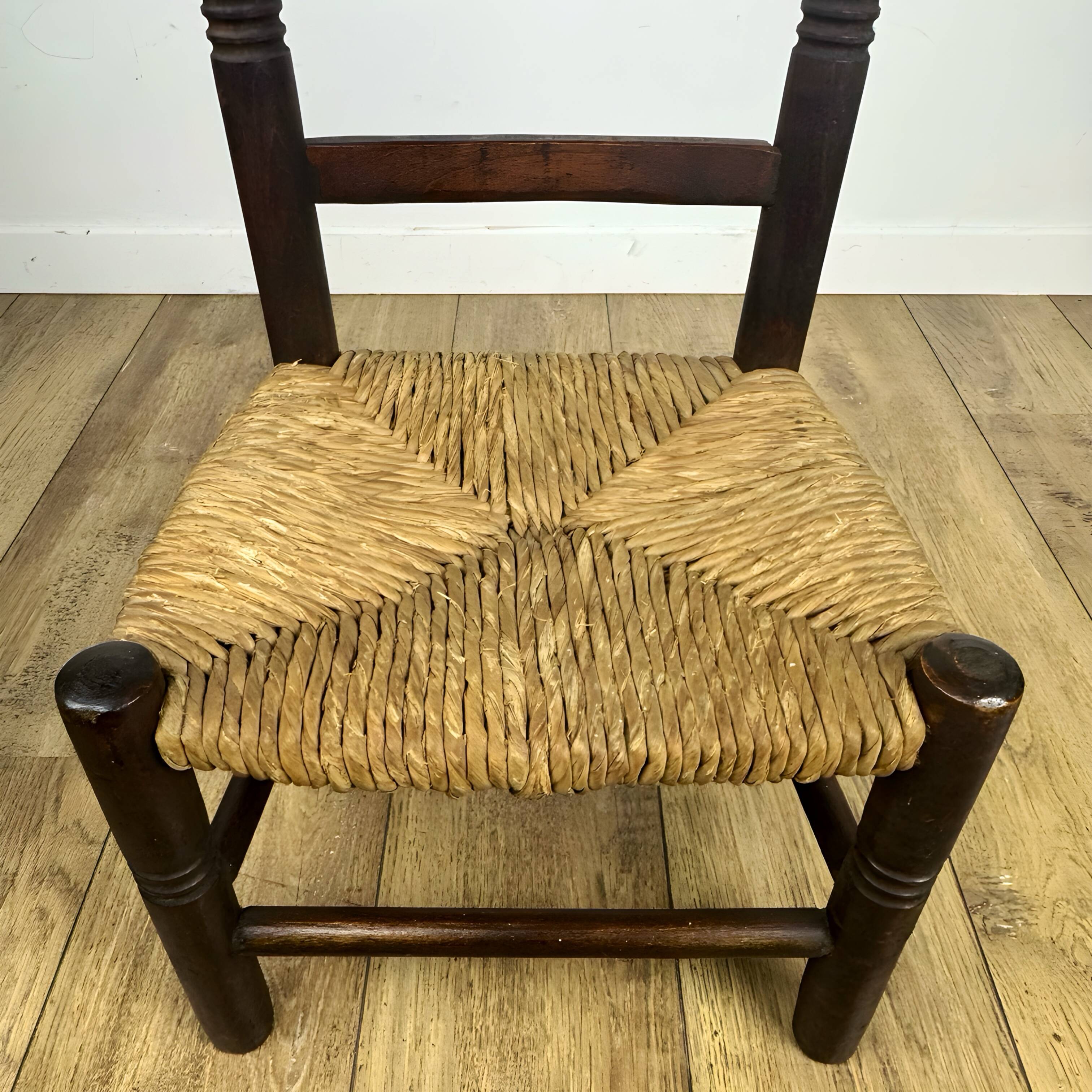 Pair of old wooden and straw children's chairs.