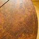 Oval extendable dining table in wood and walnut burl veneer.