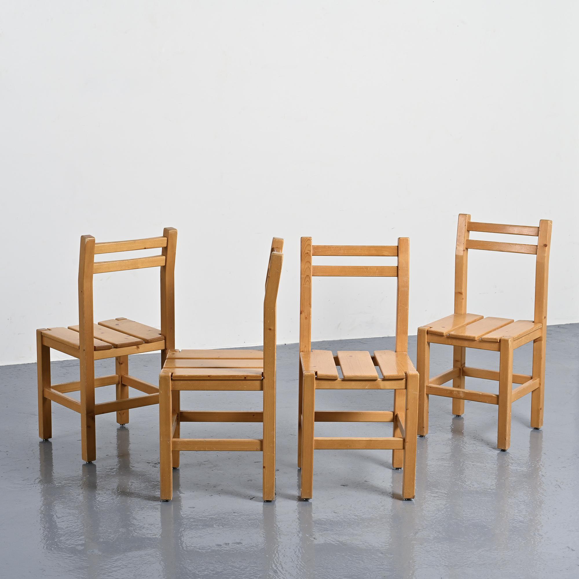 Set of four solid pine chairs by Maison Regain.
