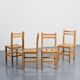 Set of four solid pine chairs by Maison Regain.