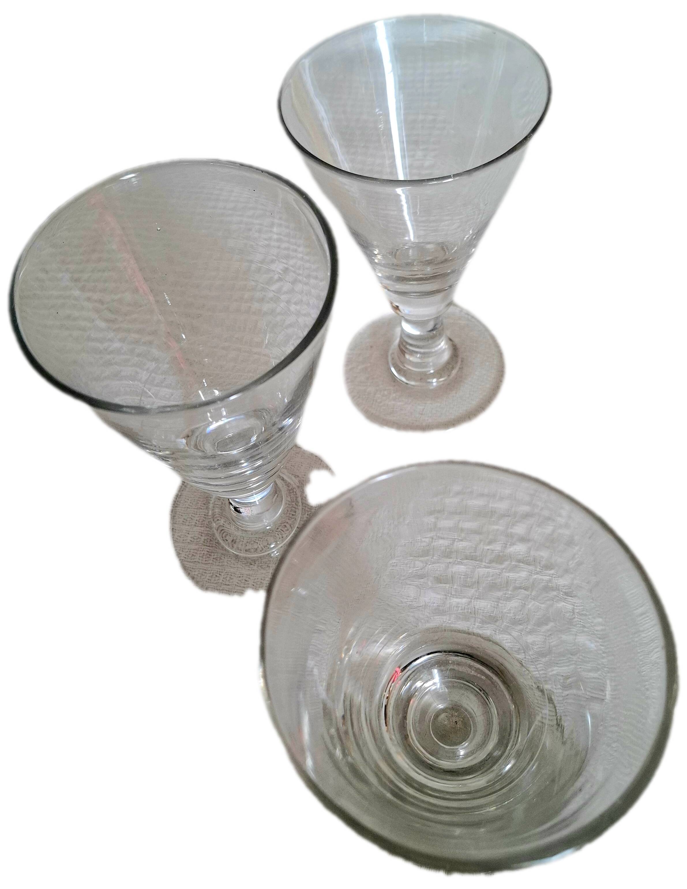 Three conical measuring glasses