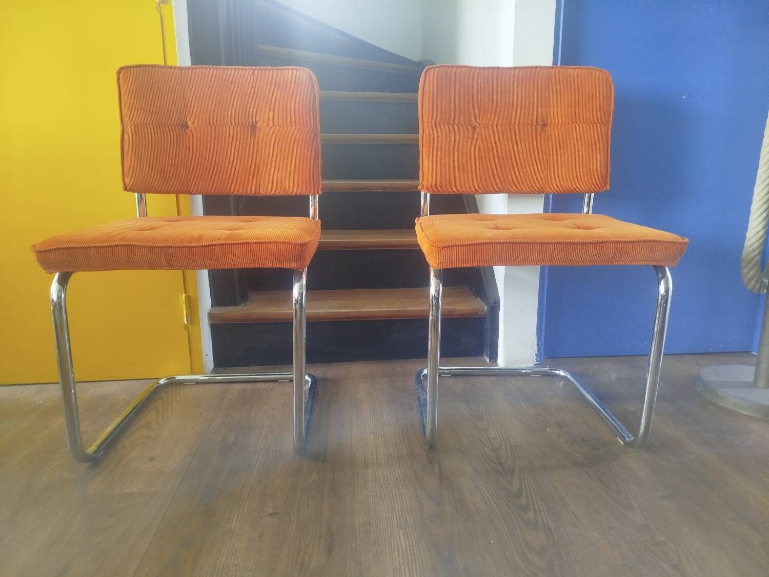 Pair of vintage cantilever chairs in chrome and orange corduroy.