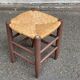 Traditional farmhouse stool in solid wood with straw seat.