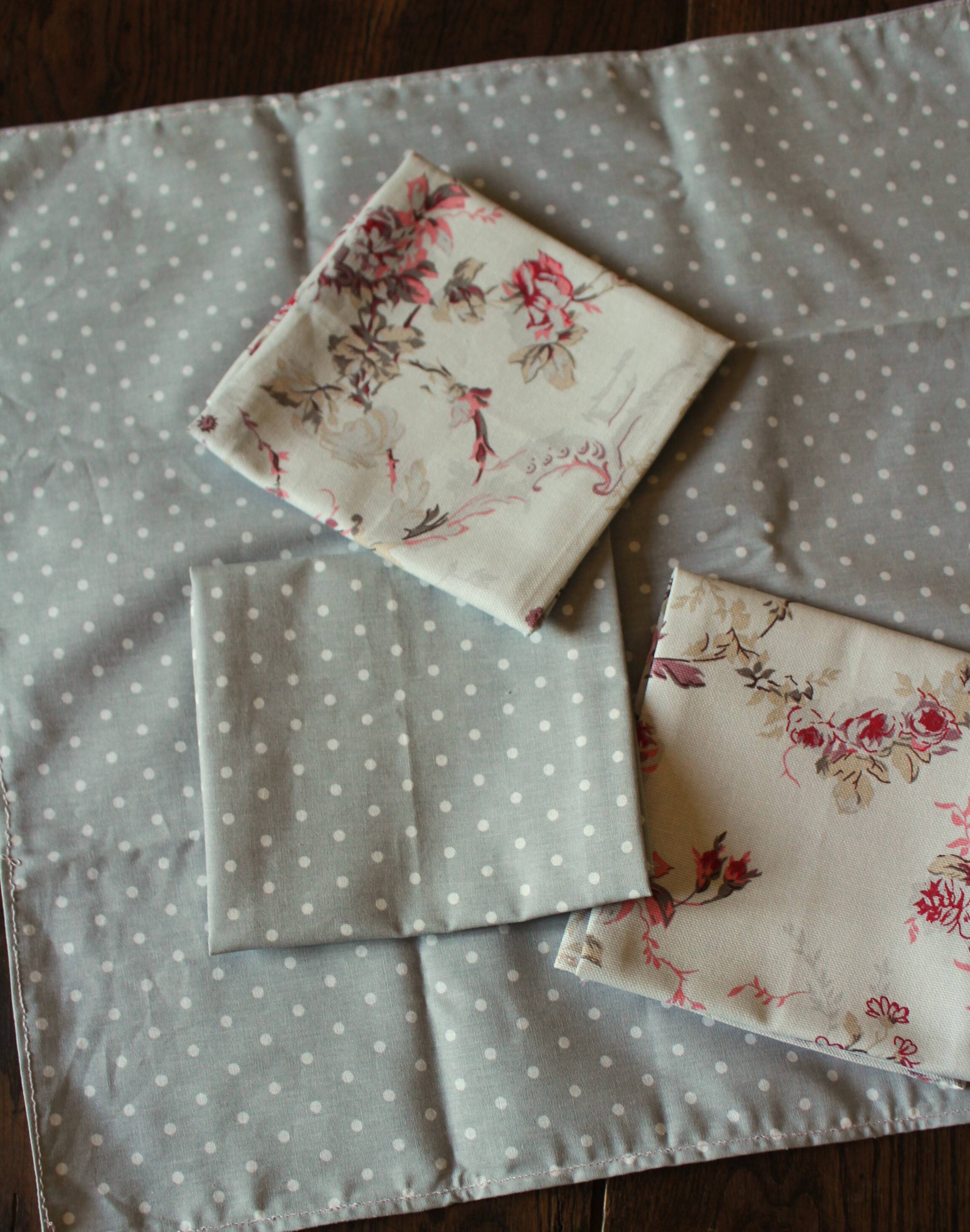 A set of 8 gray blue napkins with pink flowers and polka dots