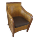Colonial style armchair in woven rattan and exotic wood