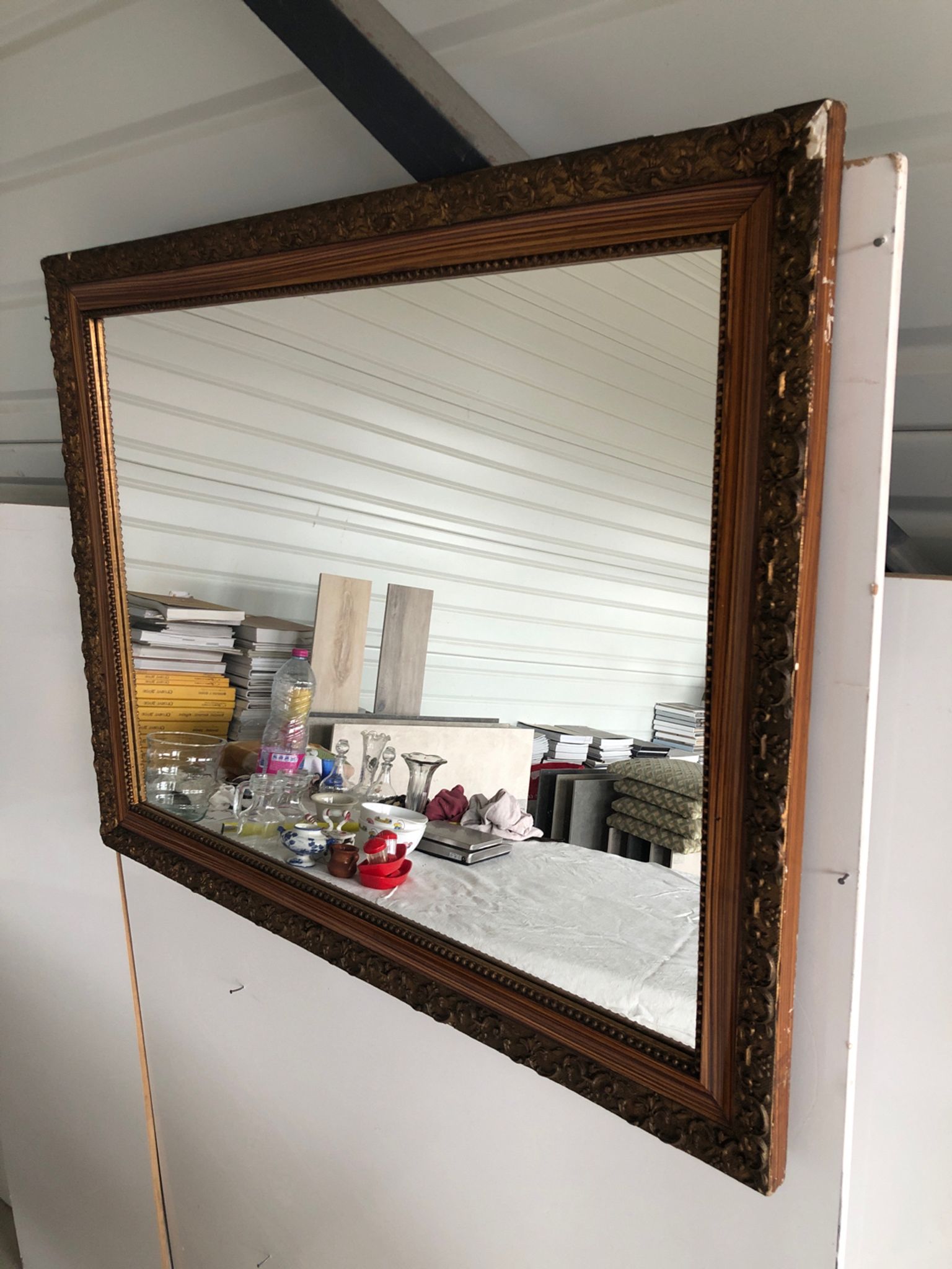 Old mirror with wooden frame and plaster moldings