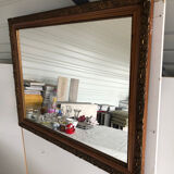 Old mirror with wooden frame and plaster moldings