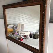 Old mirror with wooden frame and plaster moldings
