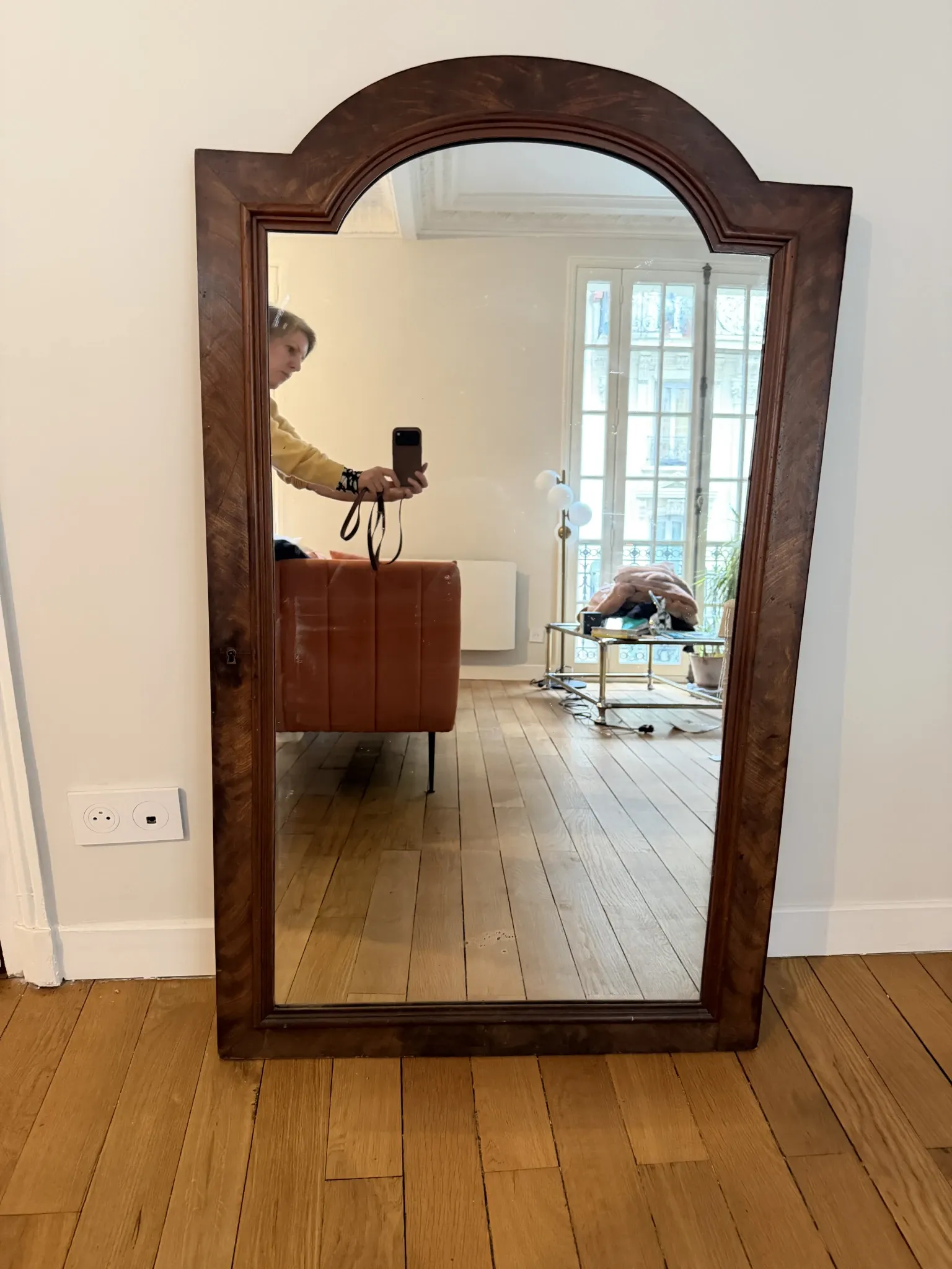 Large curved mirror with a wooden frame