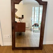 Large curved mirror with a wooden frame