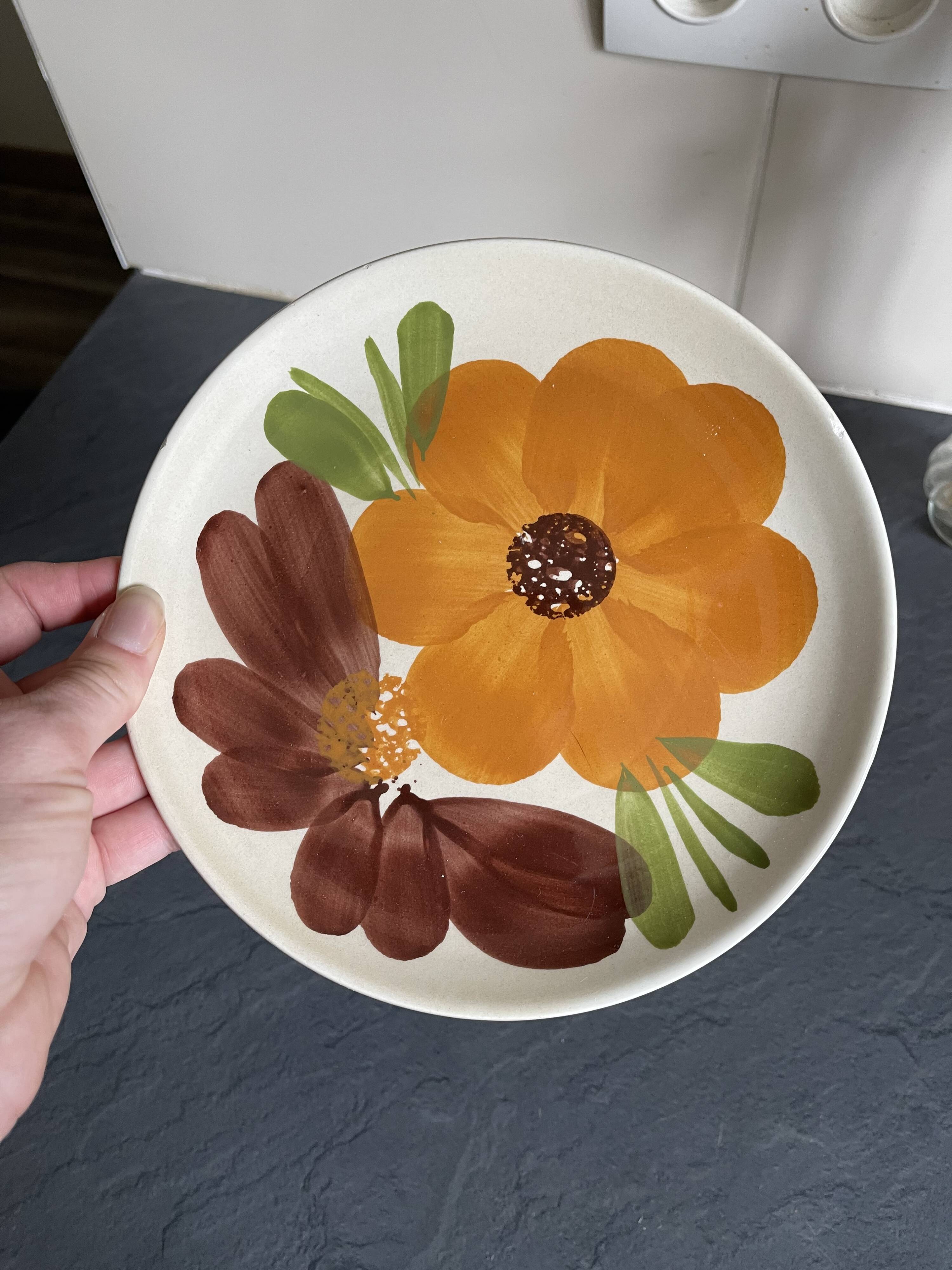 Italian ceramic plates with floral fruit designs.