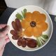 Italian ceramic plates with floral fruit designs.