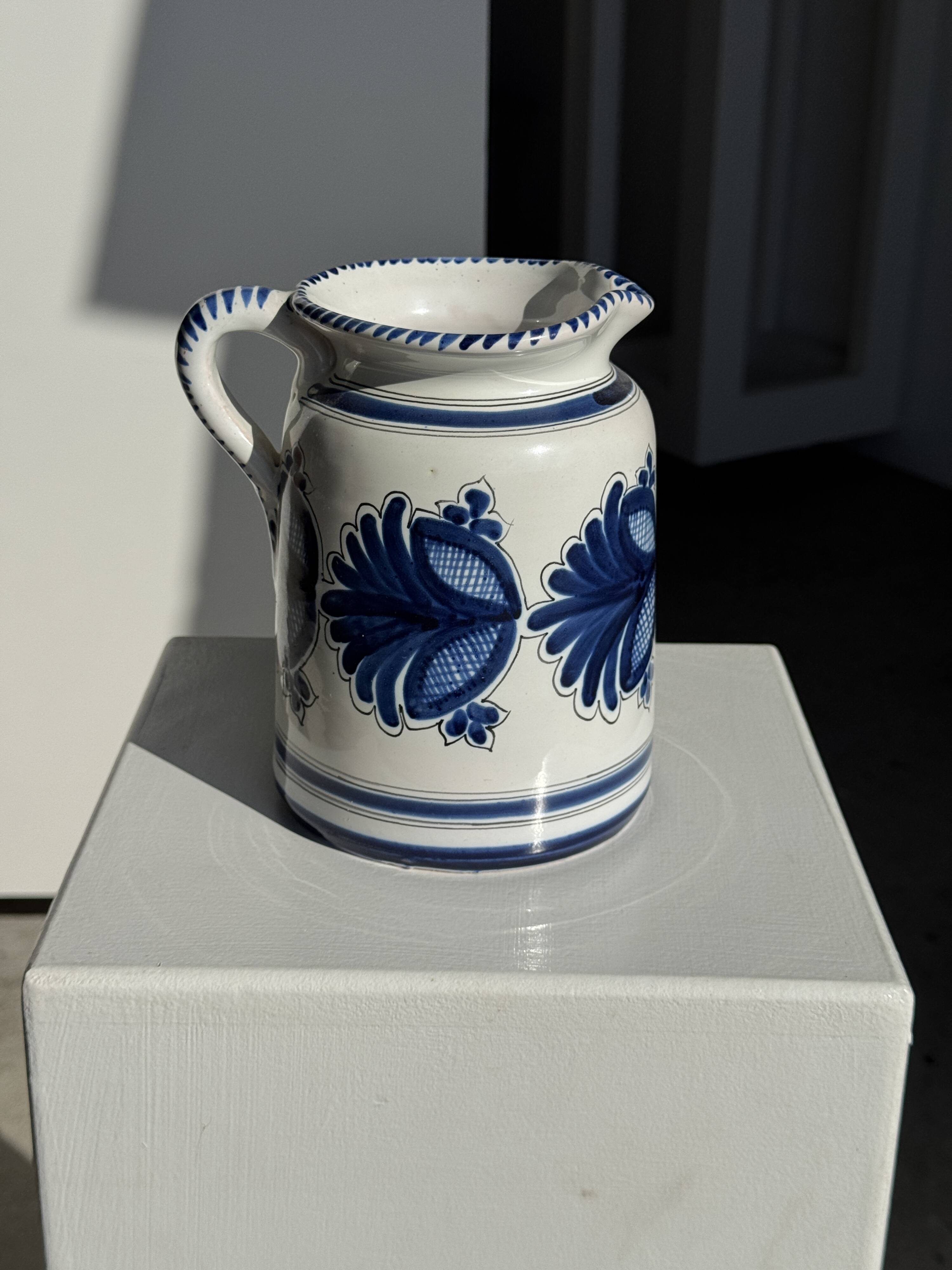 Artisan blue floral decorative carafe, height 17 cm, diameter 24.5 cm.