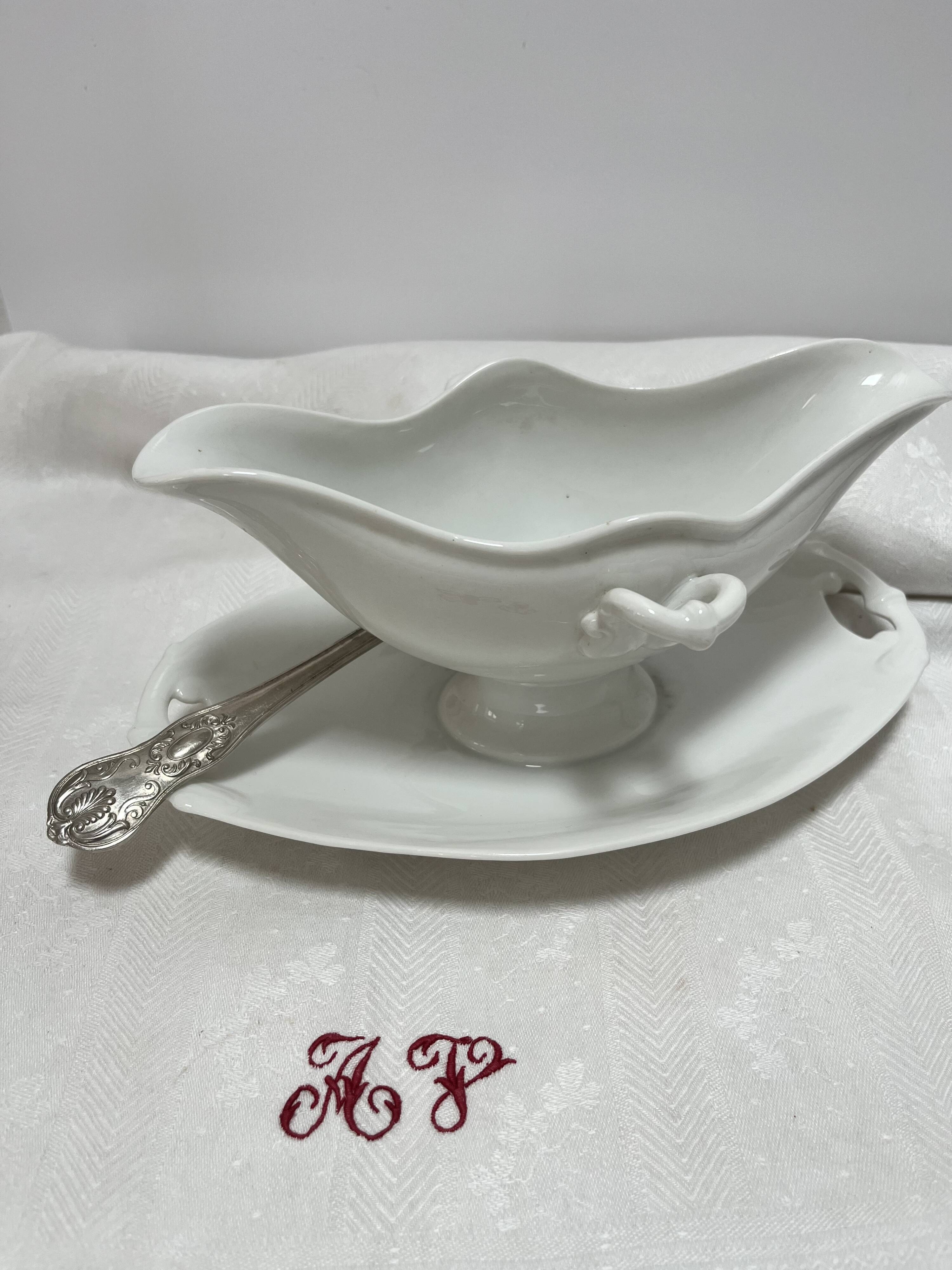 White porcelain sauce boat on tray