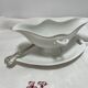 White porcelain sauce boat on tray
