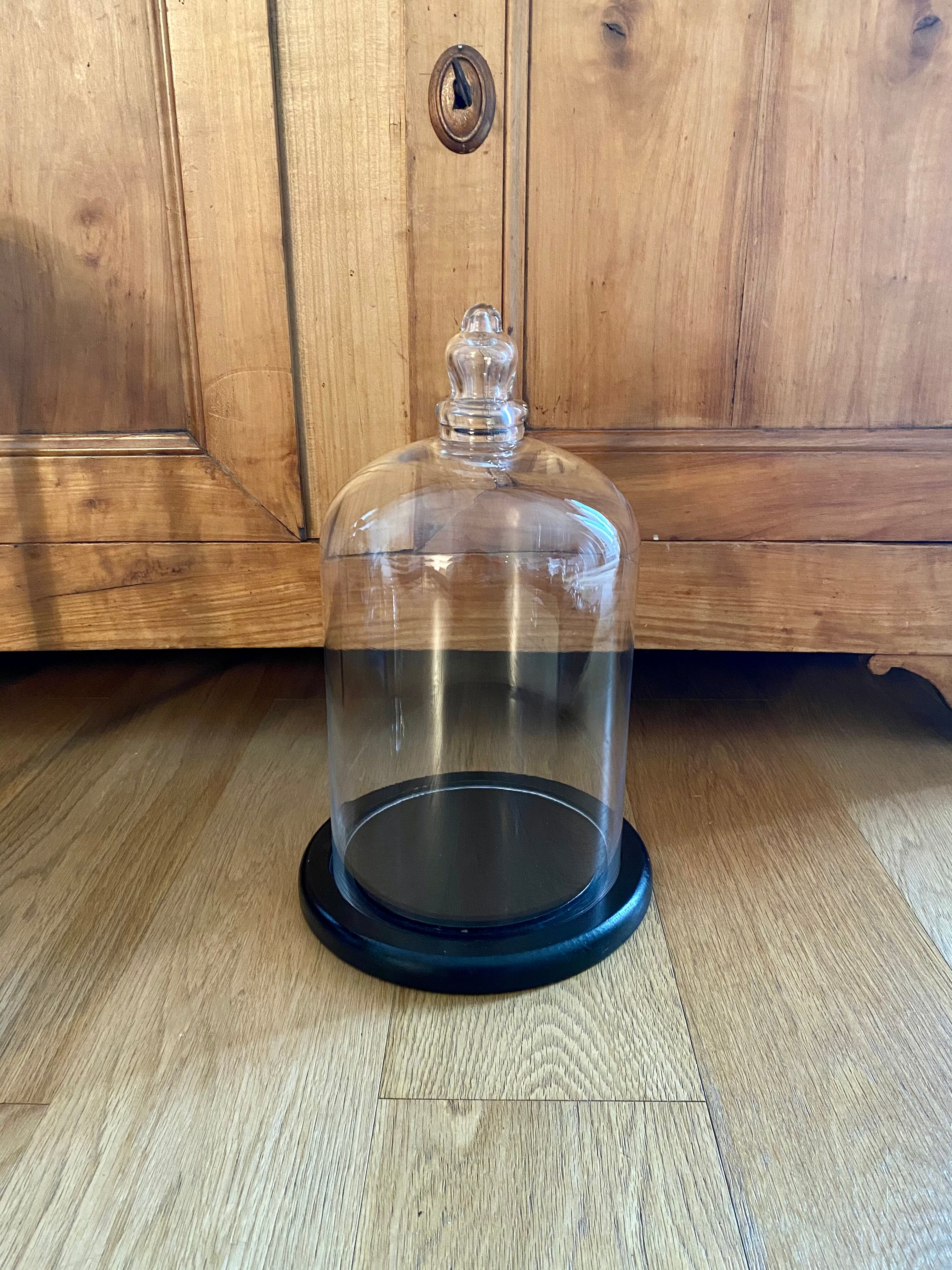 Large old glass bell and its wooden base