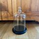 Large old glass bell and its wooden base