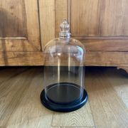 Large old glass bell and its wooden base