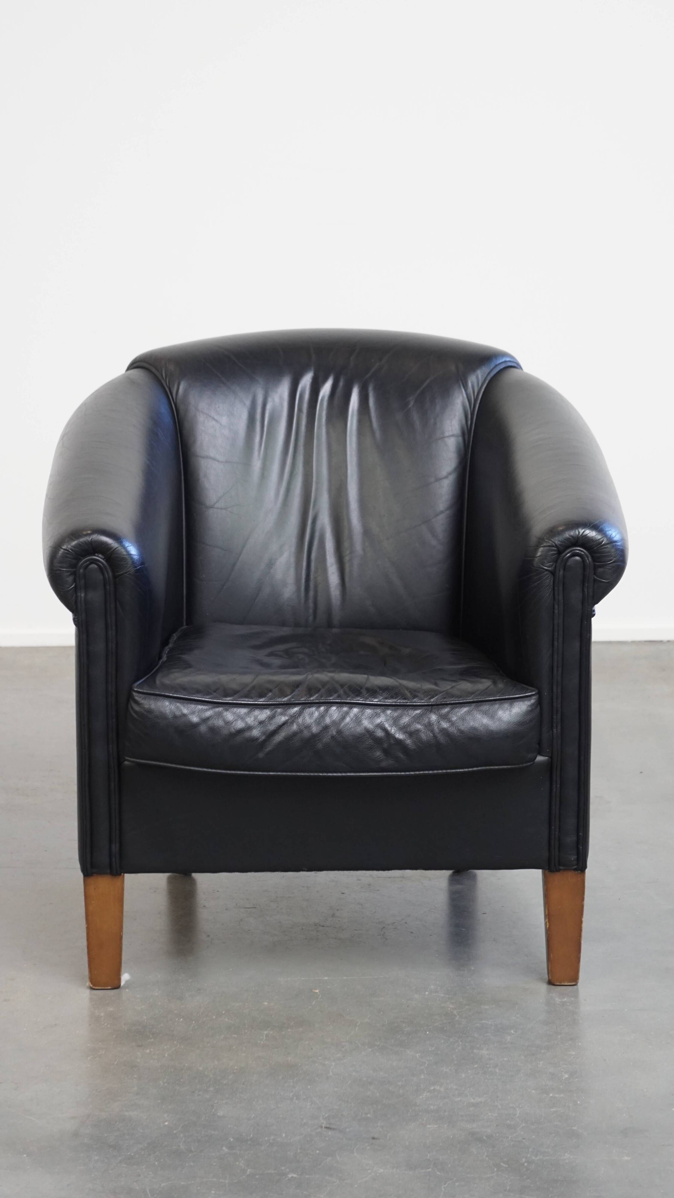 Black cowhide club chair in English style with a great luxurious design