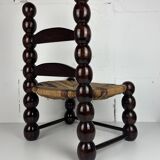 Brutalist wood turned bobbin low rush chair n the style of Charles Dudouyt