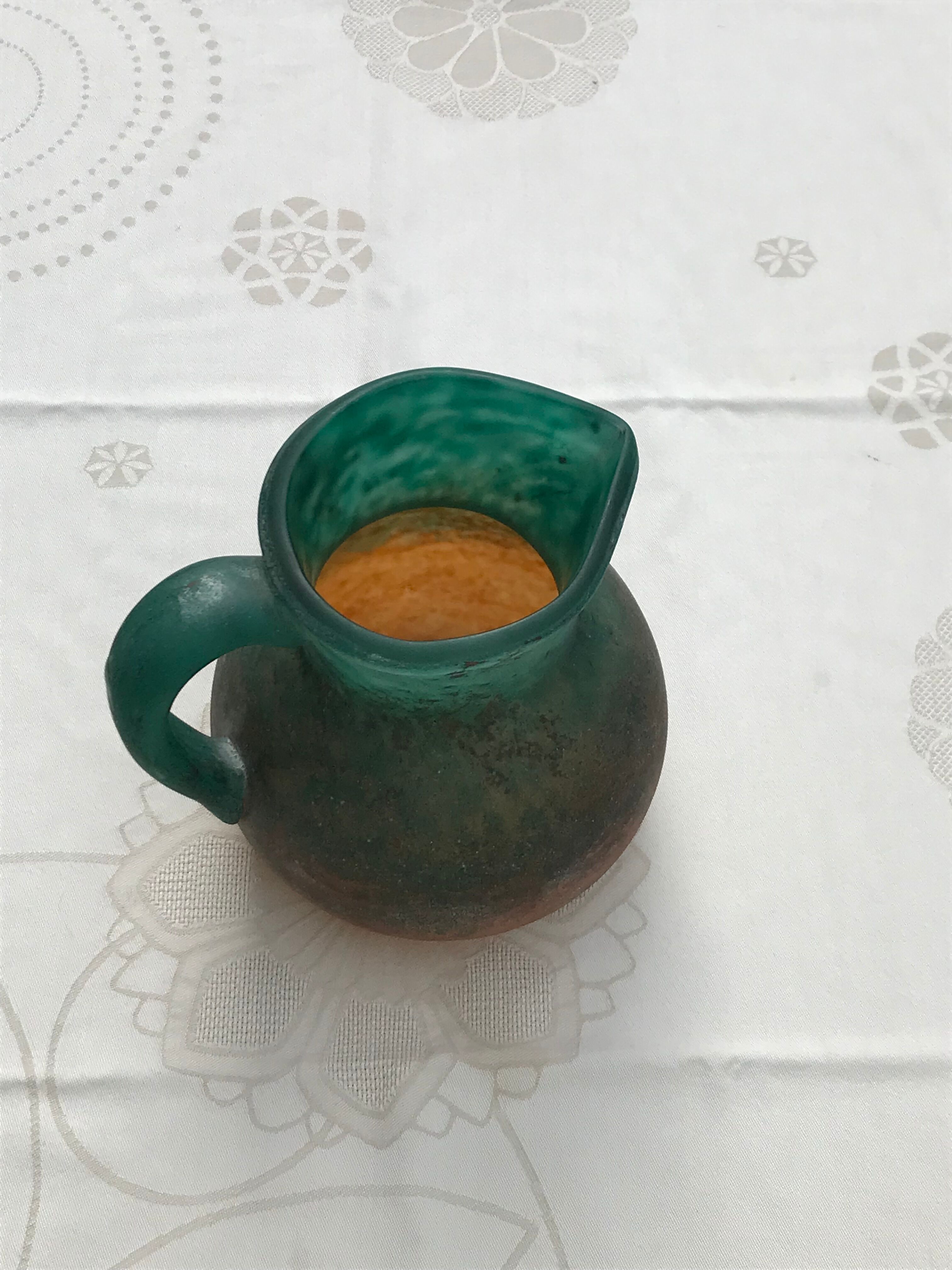 Orange and green glass paste pitcher by Georges DE FEURE