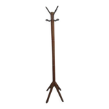 Antique light wood coat rack with splayed legs.