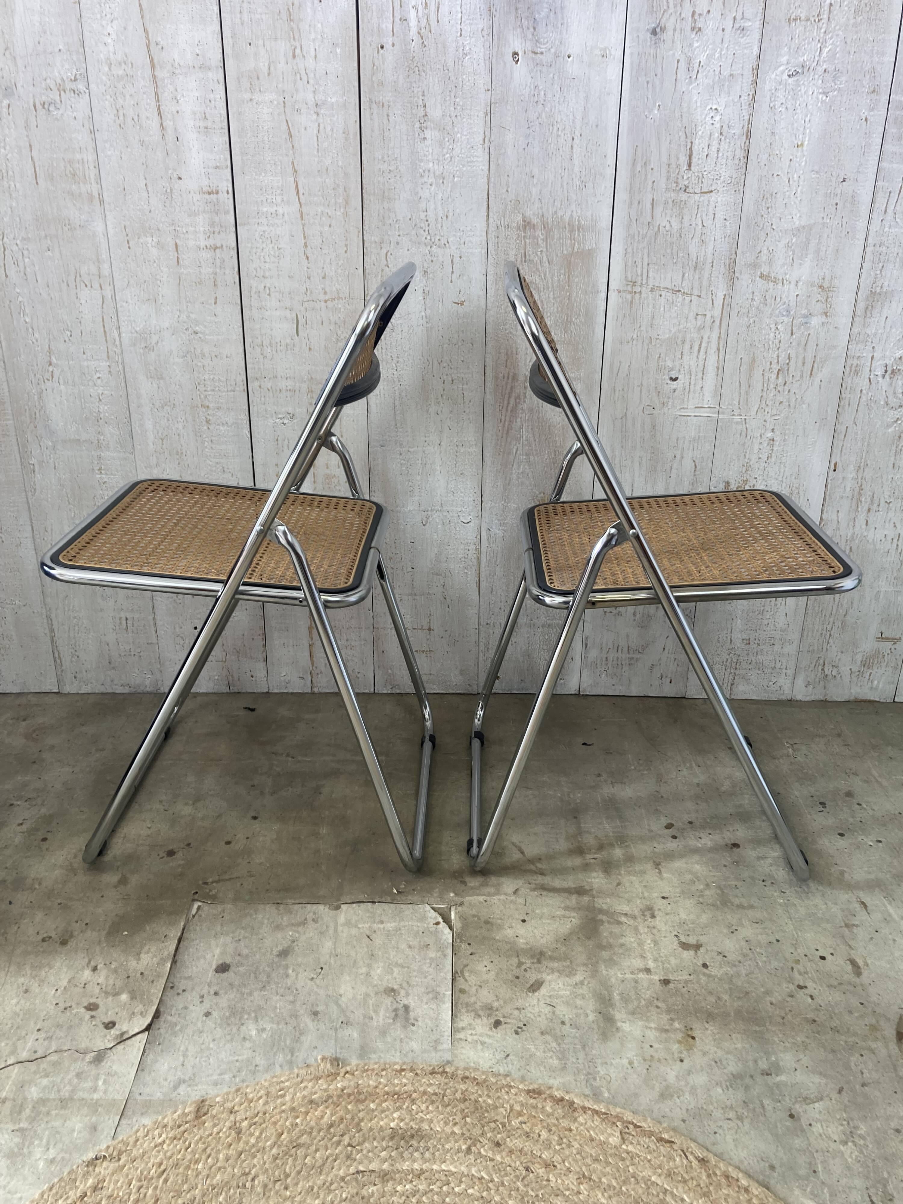 Pair of chrome and cane folding chairs
