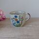 Set of two speckled stoneware mugs with small wildflower bohemian retro design.