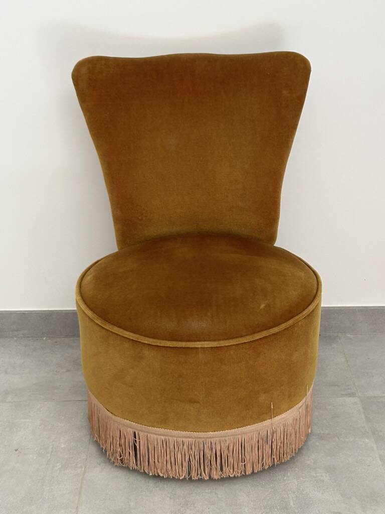 Ochre and fringed pouffe-style armchair