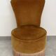 Ochre and fringed pouffe-style armchair