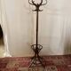 Antique curved wooden coat rack with umbrella stand.