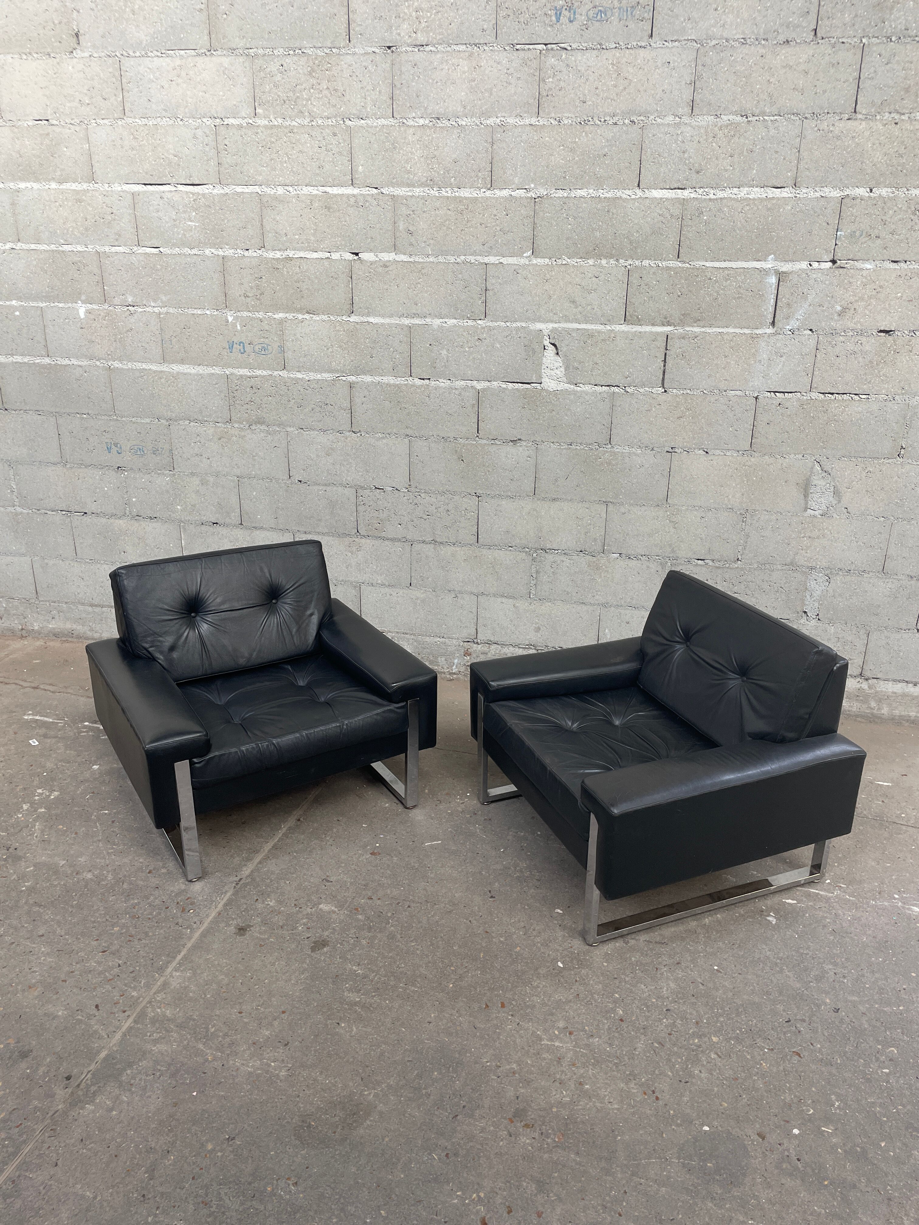 Pair of black leather armchairs
