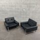 Pair of black leather armchairs