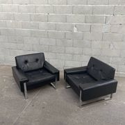 Pair of black leather armchairs