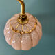 Vintage glass wall light with a pink and gold Clichy globe.