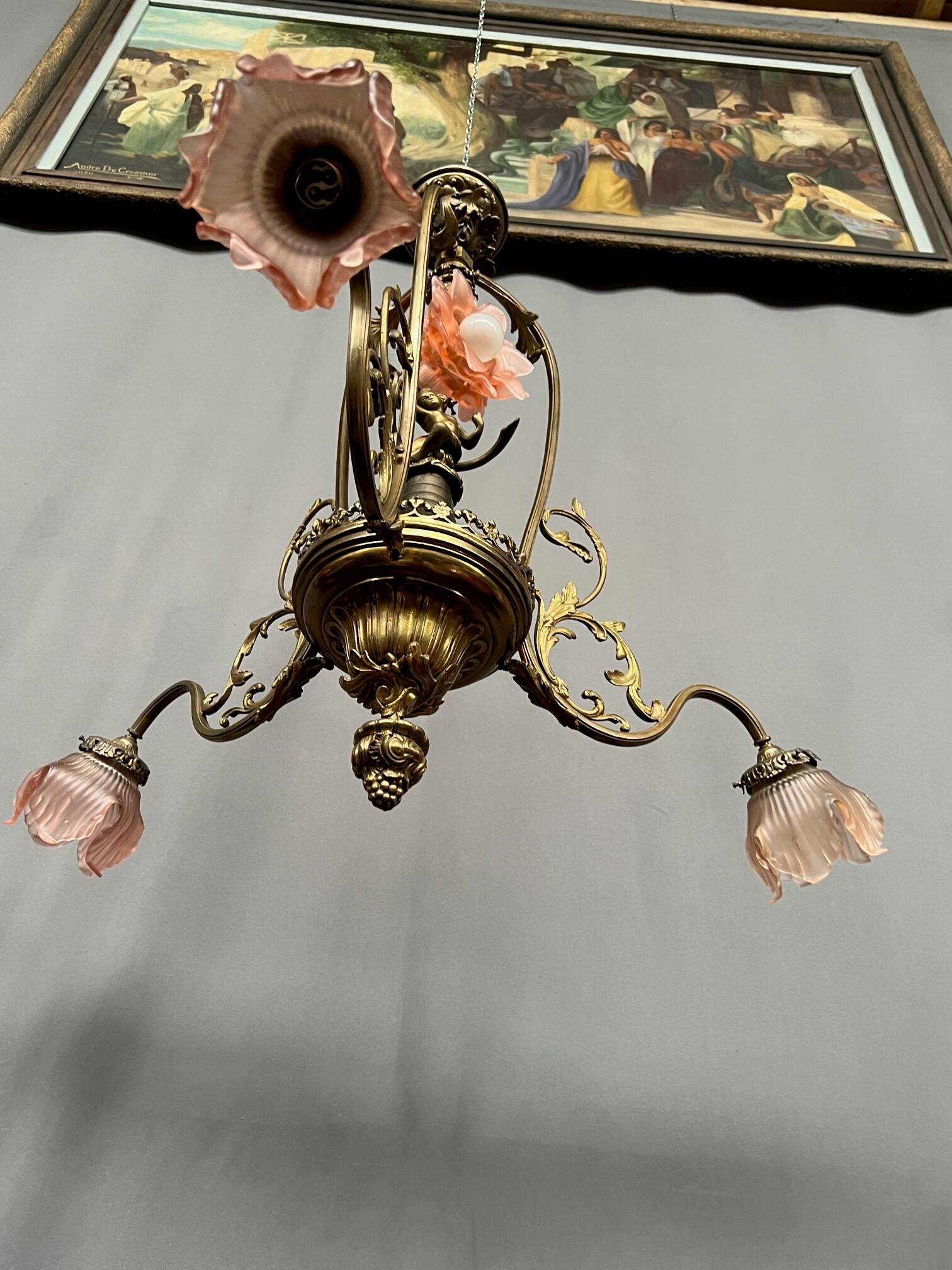 Renaissance chandelier with putti statuette.