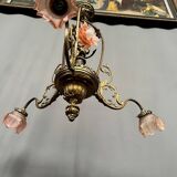 Renaissance chandelier with putti statuette.