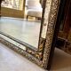 Rectangular Napoleon III mirror in moulded black and gold wood with engraved mirror decoration.