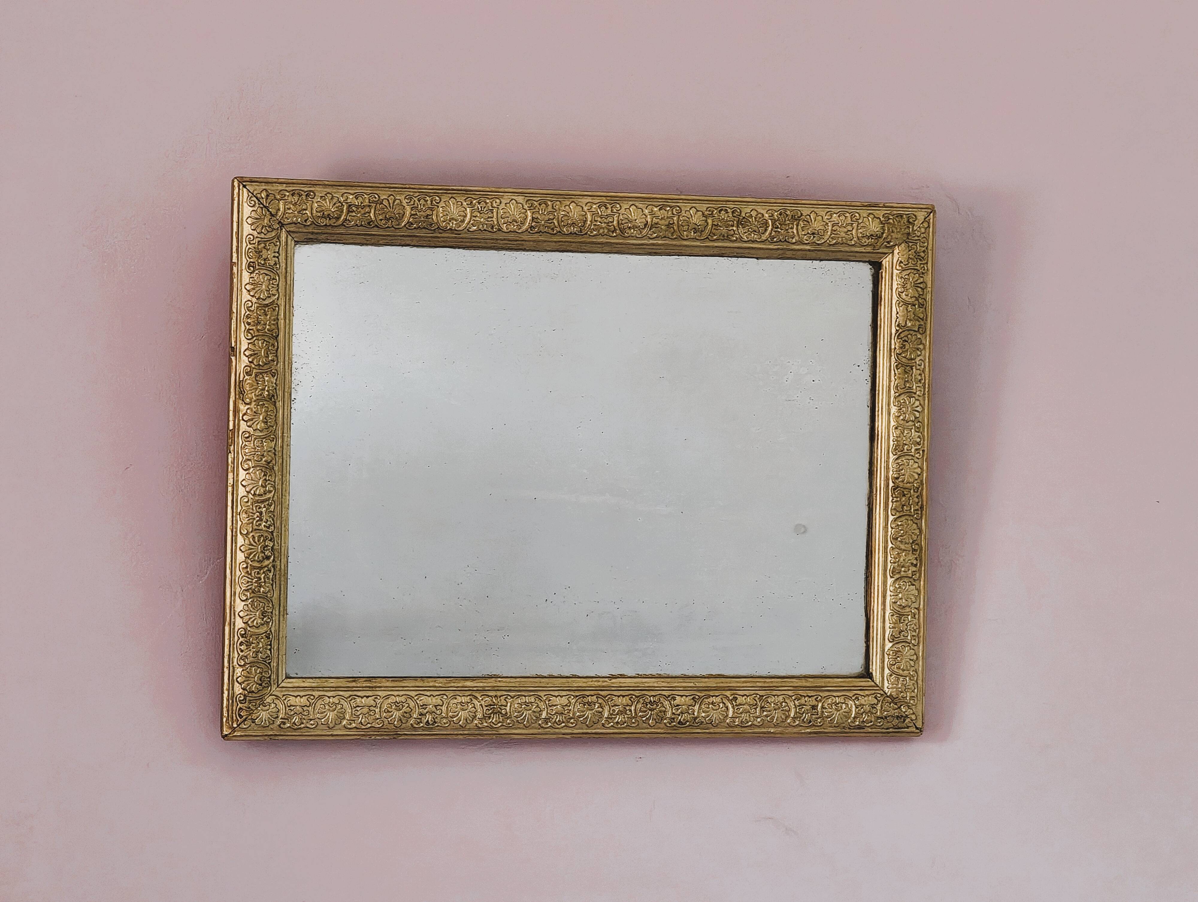 Rectangular wooden mirror with ornate Art Nouveau gold finish.