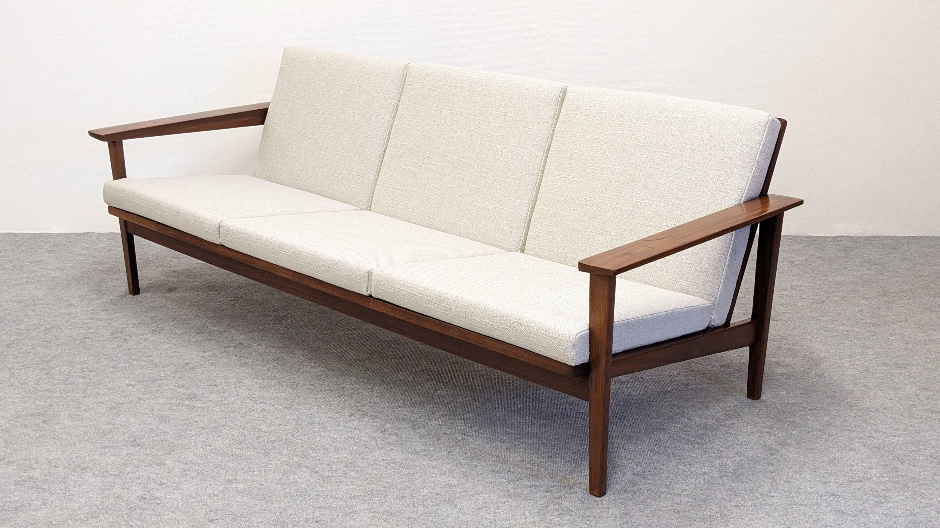 Scandinavian style three-seater sofa in teak, France circa 1950.