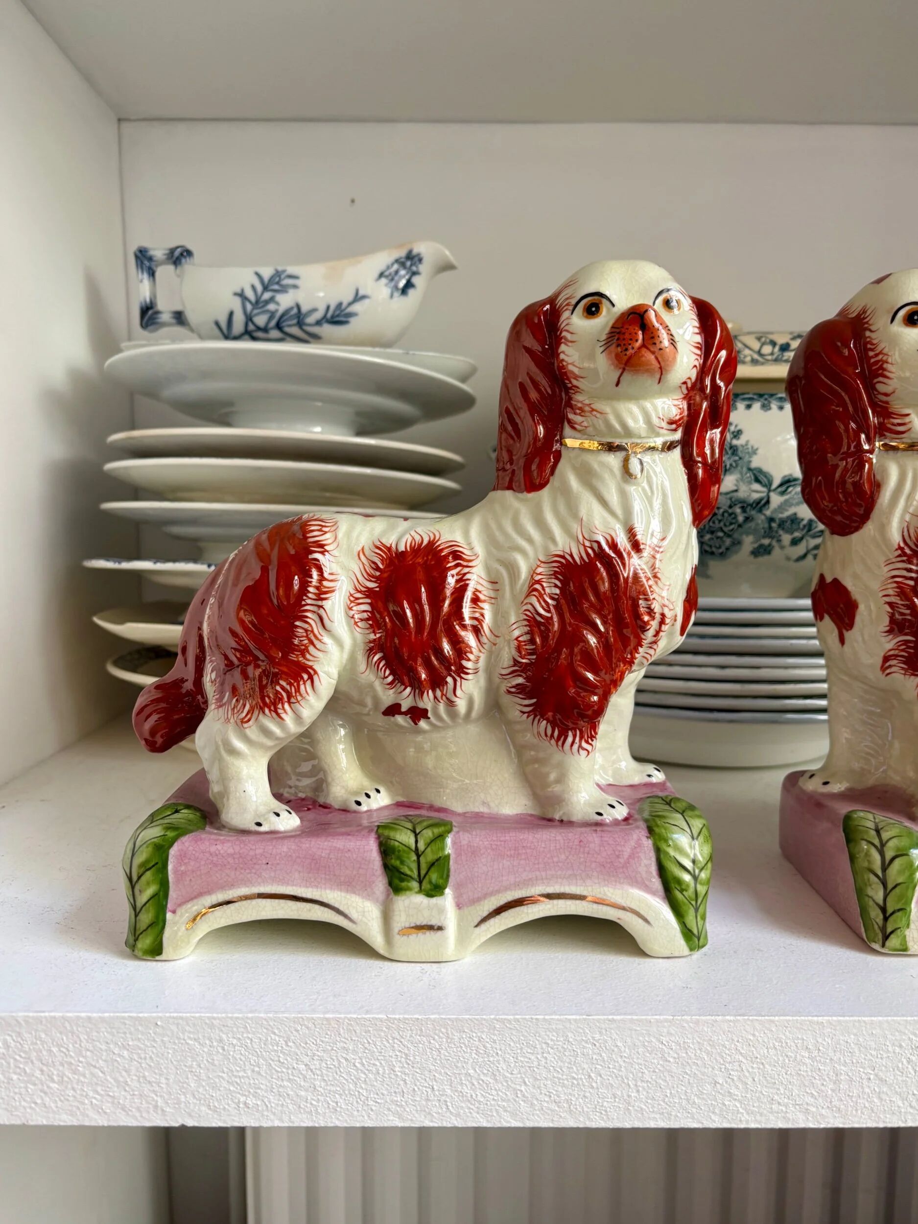 Pair of Staffordshire porcelain Cavalier King Charles dogs on terrace, 19th century.